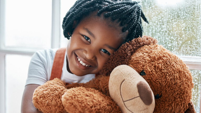 Young girl holding a teddy bear